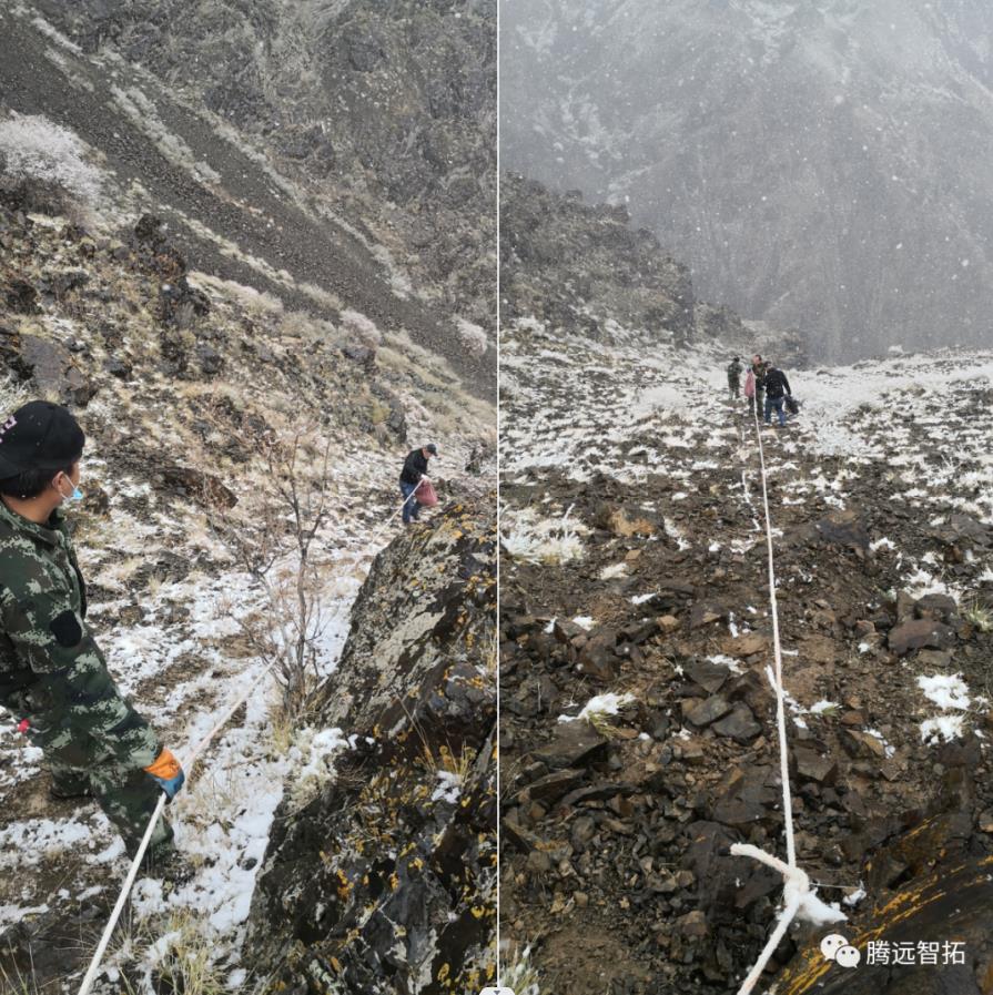 工作人员在陡峭的山上艰难的前进 工作人员在陡峭的山上艰难的前进